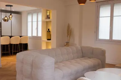 a living room with a couch and a table at Luxueuse Villa L'Olivier Cannes 4 chambres jacuzzi in Cannes