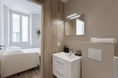 a white bathroom with a sink and a mirror at 