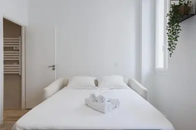 a white bed with towels on top of it at 