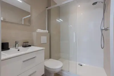 a bathroom with a shower and a toilet and a sink at 