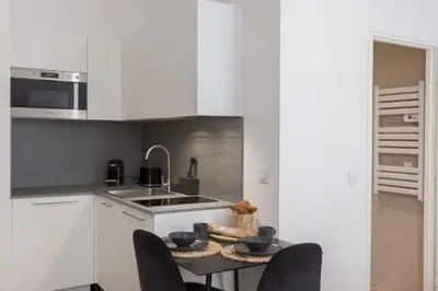 a kitchen with a table with chairs and a sink at 