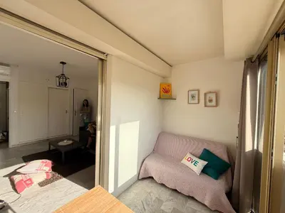 a small room with a bed and a window at Palm Beach Escape in Cannes