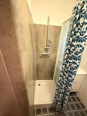 a shower with a shower curtain in a bathroom at Palm Beach Escape in Cannes