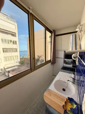a bathroom with a sink and a large window at Palm Beach Escape in Cannes