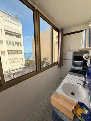 a bathroom with a sink and a window at Palm Beach Escape in Cannes