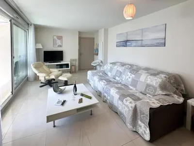 a living room with a couch and a table at PDA4 - 2 pièces avec terrasse in Cannes