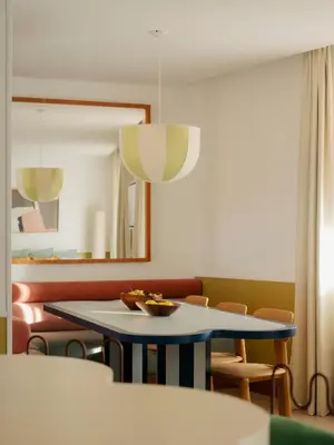 a room with a table and chairs and a mirror at Edgar Suites Cannes - Rue d'Antibes in Cannes