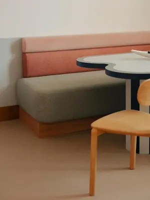 a couch with a table and a table and stool at Edgar Suites Cannes - Rue d'Antibes in Cannes