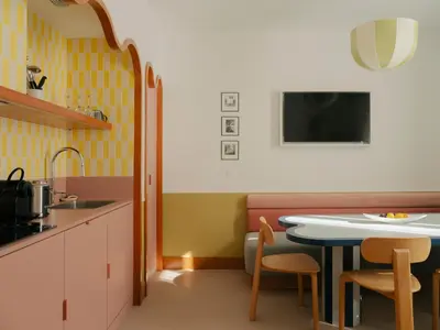 a kitchen with a table and chairs and a sink at Edgar Suites Cannes - Rue d'Antibes in Cannes