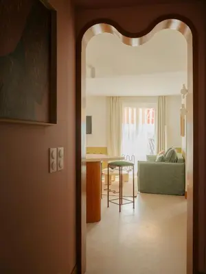 a living room with a green couch and a table at Edgar Suites Cannes - Rue d'Antibes in Cannes