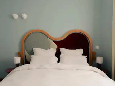 a bedroom with a large white bed with white pillows at Edgar Suites Cannes - Rue d'Antibes in Cannes