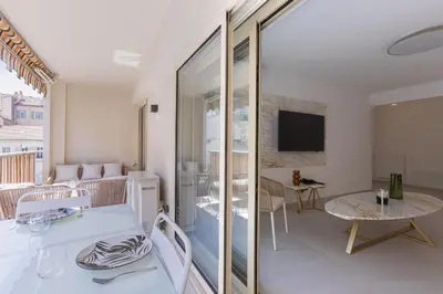 a living room with a table and a tv at 7 Pradignac by Halldis in Cannes