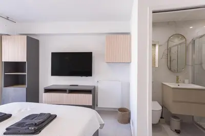 a bedroom with a bed and a bathroom with a tv at 7 Pradignac by Halldis in Cannes