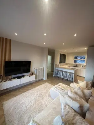 a living room with a large television and a couch at Spacieux et Moderne T2 près du centre in Cannes