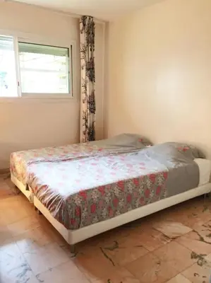 a bed in a bedroom with a window at Cannes 2pièces Croisette Martinez in Cannes
