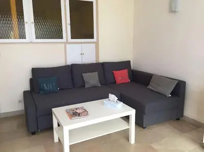 a living room with a couch and a coffee table at Cannes 2pièces Croisette Martinez in Cannes