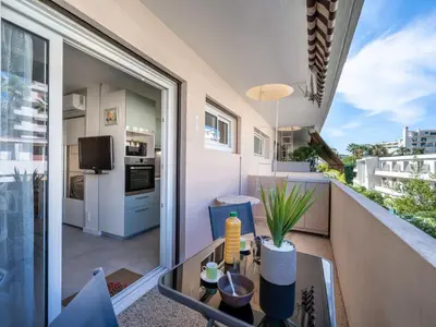 an apartment balcony with a view of a kitchen at Apartment Le Copacabana by Interhome in Cannes