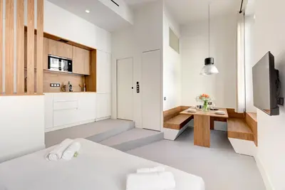 a room with a bed and a desk and a tv at Immogroom - 2 min du palais - Studio - Luxury - AC in Cannes