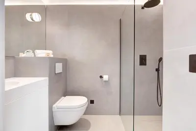 a bathroom with a shower and a toilet and a sink at Immogroom - 2 min du palais - Studio - Luxury - AC in Cannes