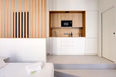 a small kitchen with a bed and a microwave at Immogroom - 2 min du palais - Studio - Luxury - AC in Cannes