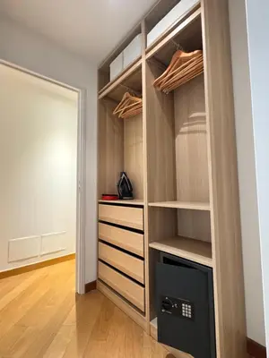 a walk in closet with wooden shelves and a door at Design Appartment 100sqm close to Palais Beach and Restaurants in Cannes