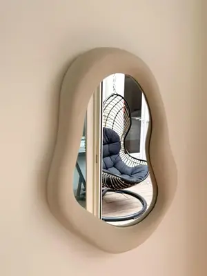 a mirror on a wall with a chair in front of it at Design Appartment 100sqm close to Palais Beach and Restaurants in Cannes