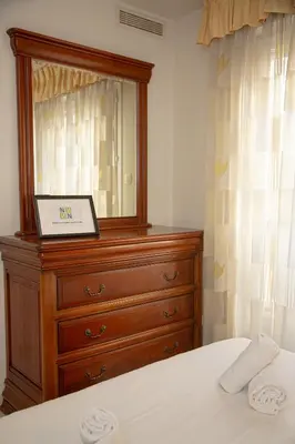 a bedroom with a dresser with a laptop on it at Le Palazzio by Connexion in Cannes