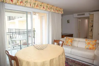 a living room with a white couch and a table at Le Palazzio by Connexion in Cannes
