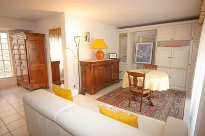 a living room with a white couch and a table at Le Palazzio by Connexion in Cannes
