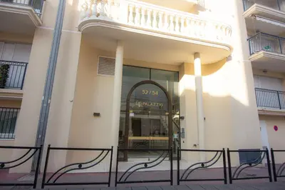 a store front of a building with a glass door at Le Palazzio by Connexion in Cannes