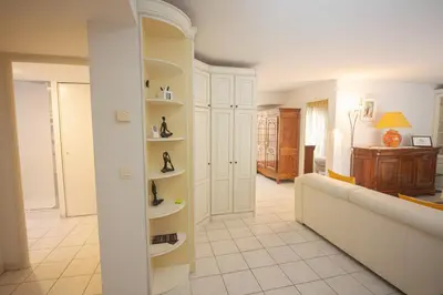 a living room with a couch and shelves with shoes at Le Palazzio by Connexion in Cannes
