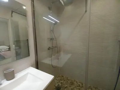 a bathroom with a shower and a white sink at Studio with sea view in Cannes