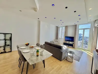 a living room with a table and a couch at charmante suite vue mer villa Carmela in Cannes