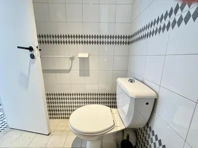 a bathroom with a white toilet in a stall at charmante suite vue mer villa Carmela in Cannes