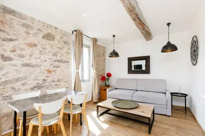 a living room with a couch and a table at CASA RIVIERA Ecrin moderne ,tout confort, 300 m Croisette in Cannes