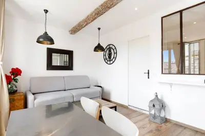 a living room with a couch and a table and chairs at CASA RIVIERA Ecrin moderne ,tout confort, 300 m Croisette in Cannes