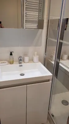 a white bathroom with a sink and a shower at Studio in Cannes