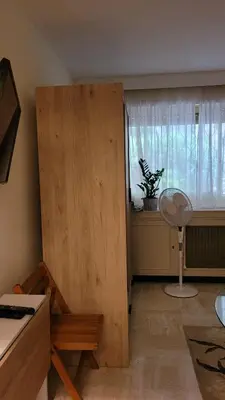 a room with a desk and a window with a fan at Studio in Cannes