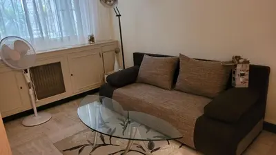 a living room with a couch and a glass table at Studio in Cannes