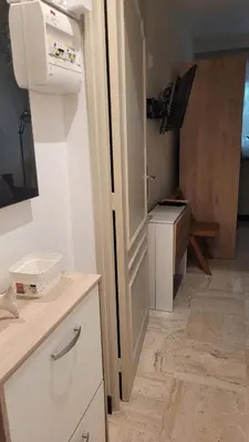 a room with a kitchen with a sink and a microwave at Studio in Cannes