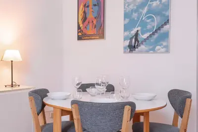 a table with wine glasses and a picture on the wall at The Artists’ Retreat – Comfort in the Heart of Cannes in Cannes