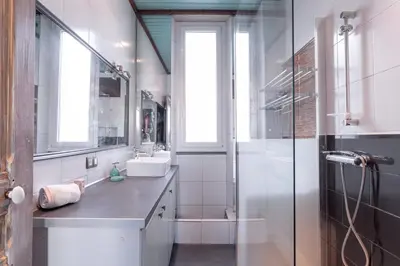 a bathroom with a glass shower and a sink at The Artists’ Retreat – Comfort in the Heart of Cannes in Cannes