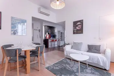 a living room with a white couch and a table at The Artists’ Retreat – Comfort in the Heart of Cannes in Cannes