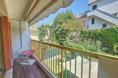 a balcony with a table and a chair on it at Henri Camille Real Estate- Mikaela - Studio with terrace in Cannes