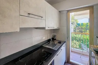 a small kitchen with a sink and a window at Henri Camille Real Estate- Mikaela - Studio with terrace in Cannes