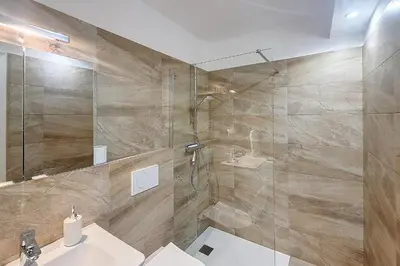 a bathroom with a shower and a toilet and a sink at Henri Camille Real Estate- Mikaela - Studio with terrace in Cannes