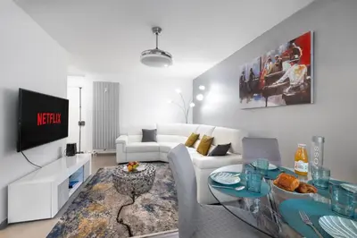 a kitchen and living room with a table and chairs at Suite Ioana - Appartement à Cannes in Cannes
