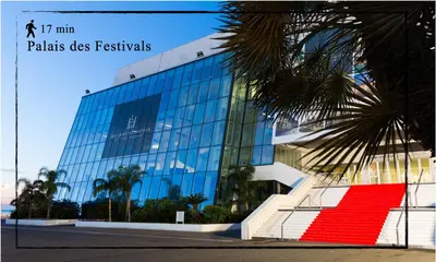 a glass building with a red rug in front of it at Suite Ioana - Appartement à Cannes in Cannes