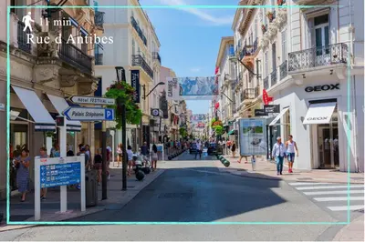 a city street with people walking down the street at Suite Ioana - Appartement à Cannes in Cannes