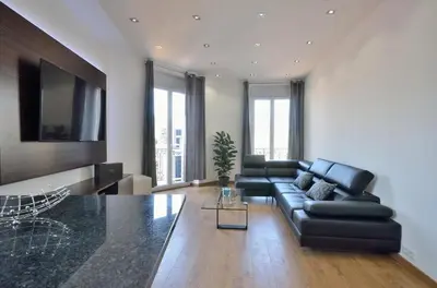 a living room with a couch and a table at Très bel appartement centre-ville in Cannes